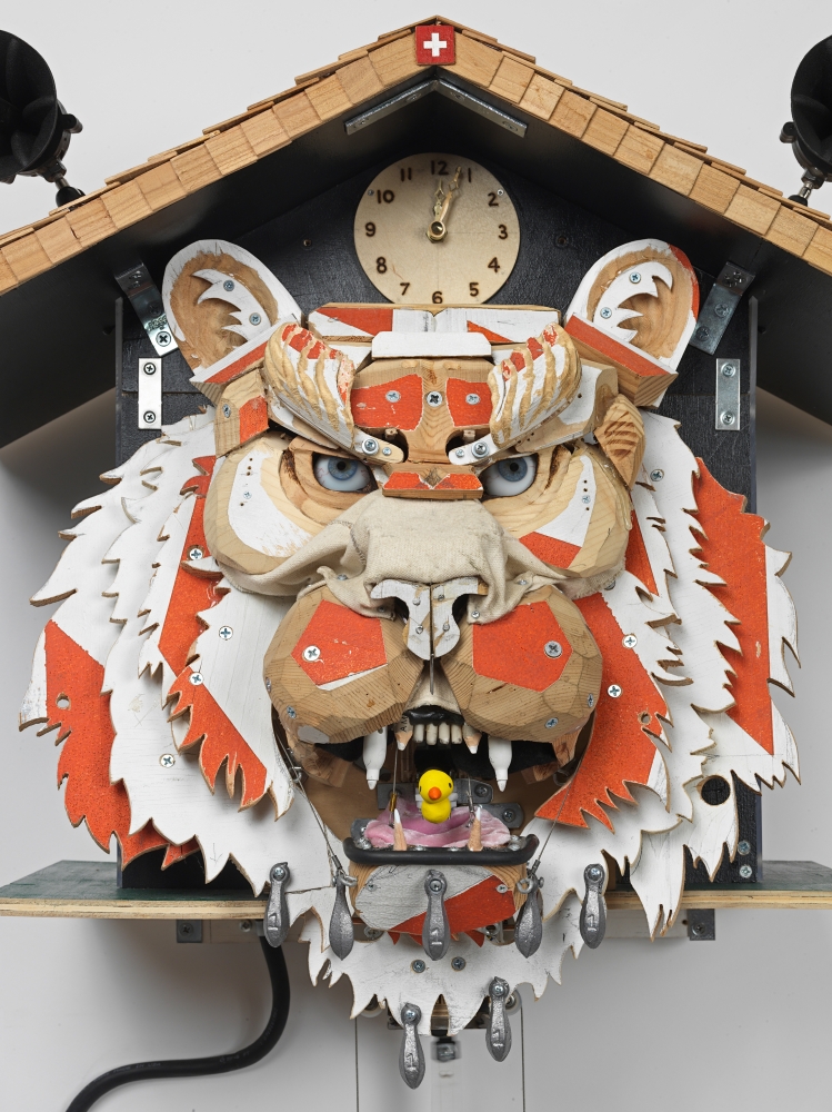 Tiger head cuckoo clock made out of wood with visible screws and glue drops