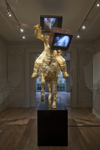 Gold leaf sculpture of a man on a horse with both heads replaced with televisions by The Bruce High Quality Foundation